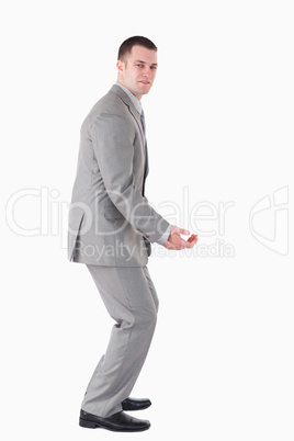 Portrait of a handsome young businessman carrying something