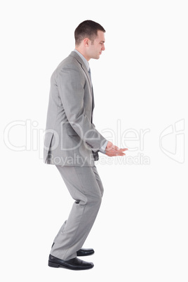 Portrait of a businessman carrying something heavy