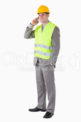 Portrait of a smiling builder making a phone call