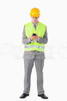 Portrait of a young builder using his cellphone