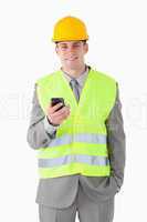 Portrait of a young builder holding his cellphone