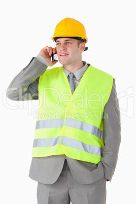 Portrait of a handsome builder using his cellphone