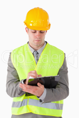 Portrait of a young builder taking notes