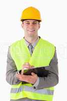 Portrait of a smiling builder taking notes