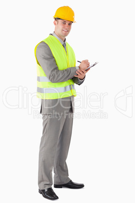 Portrait of a smiling contractor taking notes