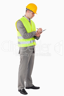 Portrait of a young contractor taking notes