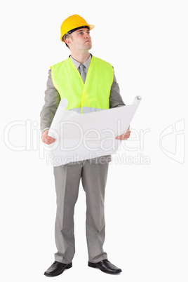 Portrait of an architect holding a plan while looking around