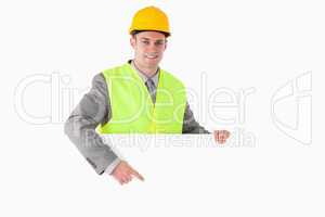Smiling builder pointing at something