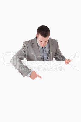 Portrait of a businessman pointing at something on a panel