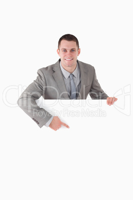 Portrait of a smiling entrepreneur pointing at something