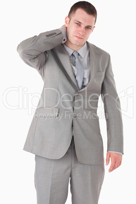Portrait of a young businessman having a neck pain