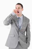 Portrait of a businessman yawning