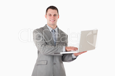 Businessman posing with a laptop