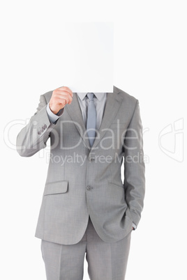 Portrait of a businessman hiding his face behind a blank panel