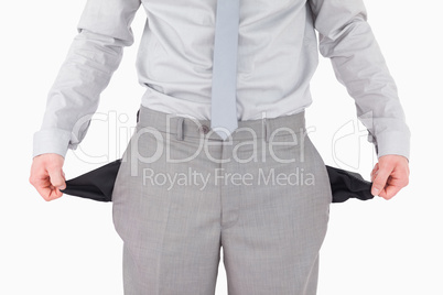 Businessman showing his empty pockets