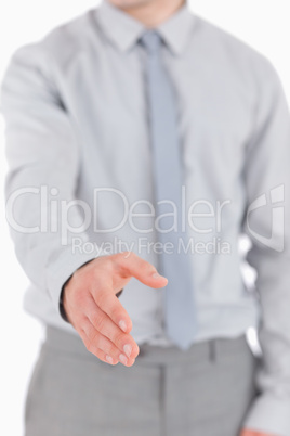 Portrait of a young businessman giving his hand