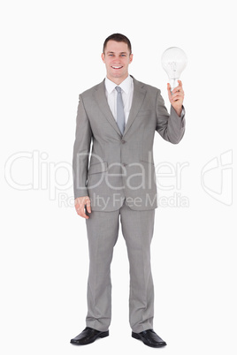 Portrait of a businessman holding a bulb