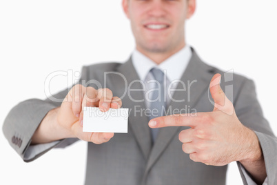 Businessman pointing at a blank business card