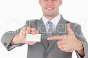Businessman pointing at a blank business card