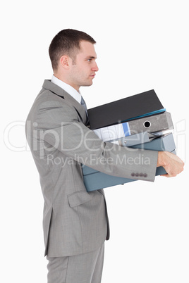 Portrait of a businessman holding a stack of binders