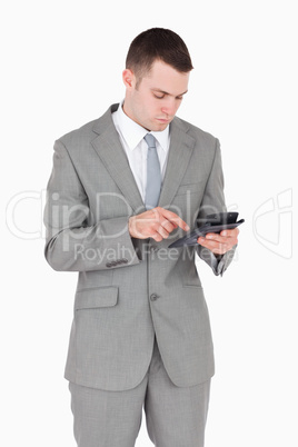 Portrait of a businessman working with a calculator