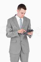 Portrait of a businessman working with a calculator