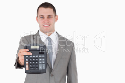 Businessman showing a calculator