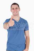 Portrait of a young man with the thumb up