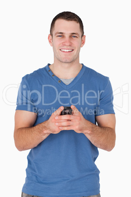 Portrait of a smiling man holding his mobile phone