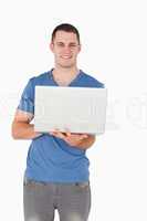 Portrait of a man holding a laptop