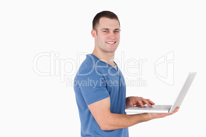 Smiling man using a laptop