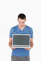 Portrait of a young man looking at a laptop