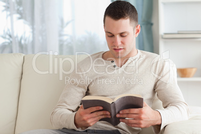 Young man reading a book