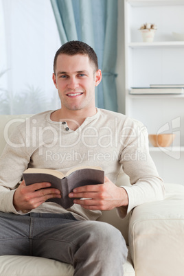 Portrait of a man holding a book