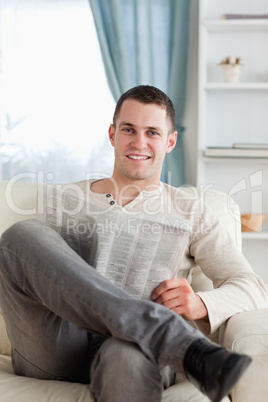 Portrait of a smiling man reading a newspaper