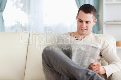 Young man reading a newspaper