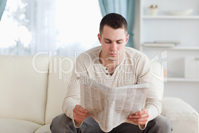 Serious man reading a newspaper