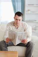 Portrait of a young man reading a newspaper