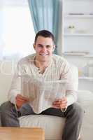 Portrait of a smiling man holding a newspaper