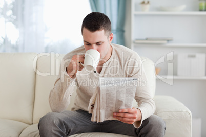 Man reading the news while drinking a tea