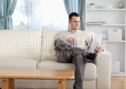 Man having a coffee while reading the news