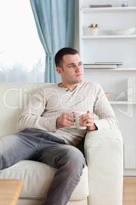 Portrait of a handsome man having a coffee