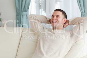 Laughing man relaxing on a sofa