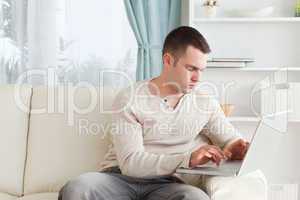 Man typing on his laptop