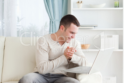 Happy man using a laptop