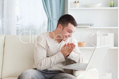 Happy man using a notebook