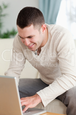 Portrait of a smiling man using a notebook