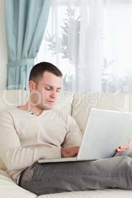 Portrait of a man relaxing with a laptop