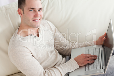 Young man relaxing with a notebook