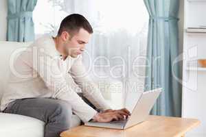 Young man typing on his laptop